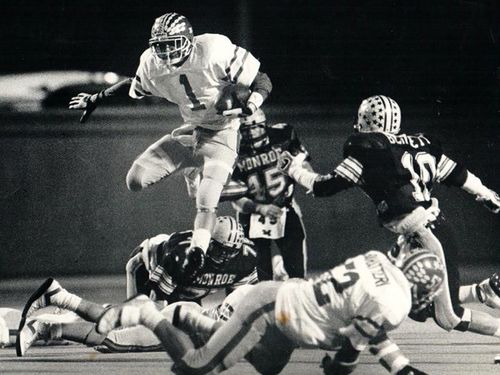 PURCELL-MARIAN FOOTBALL 1986 ball carrier leaping over defenders